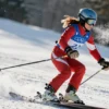 a woman skiing down a snowy slope