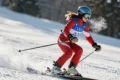 a woman skiing down a snowy slope